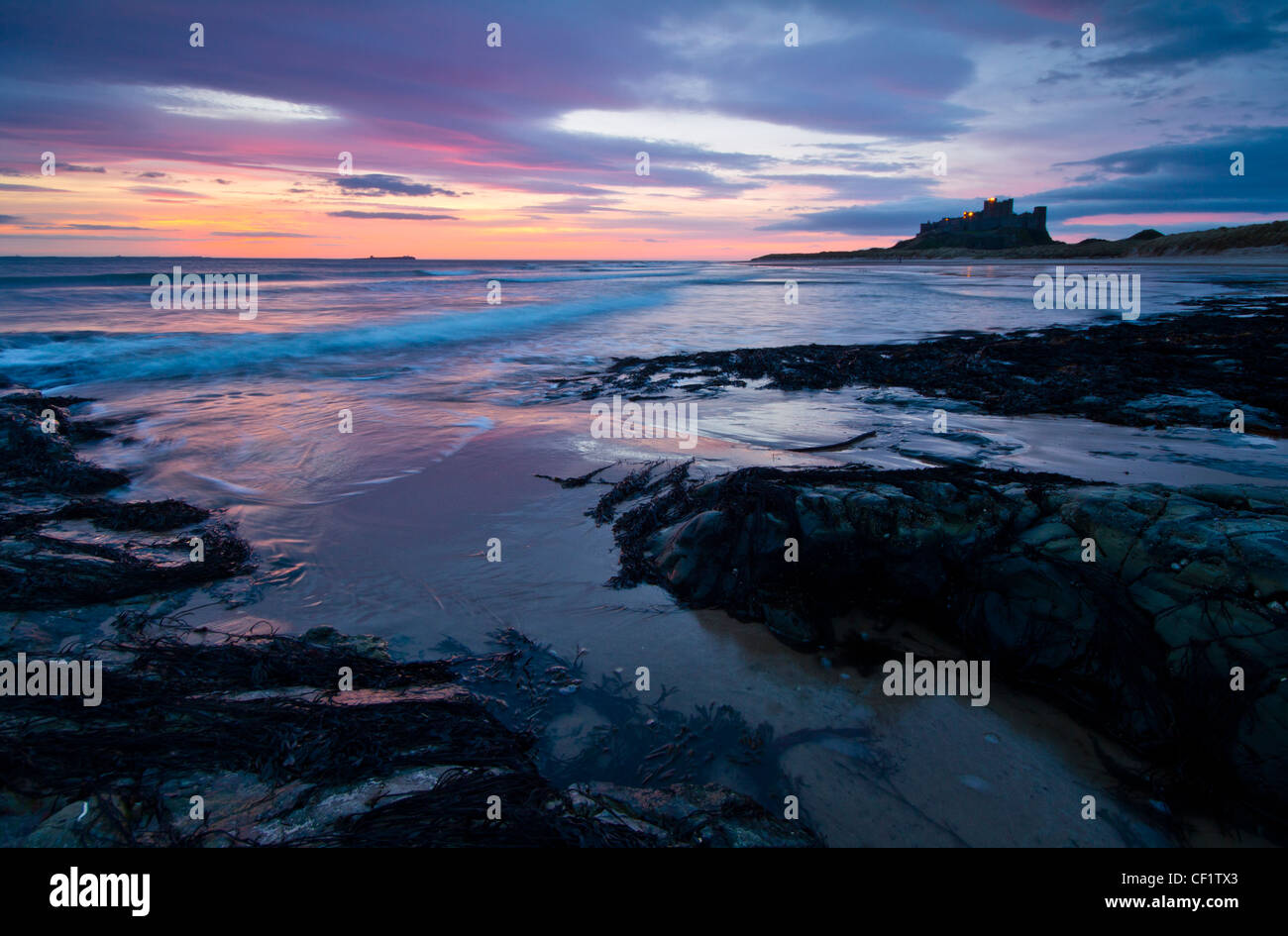 Bamburgh Castle, one of Northumberland's most iconic buildings just before sunrise. Stock Photo