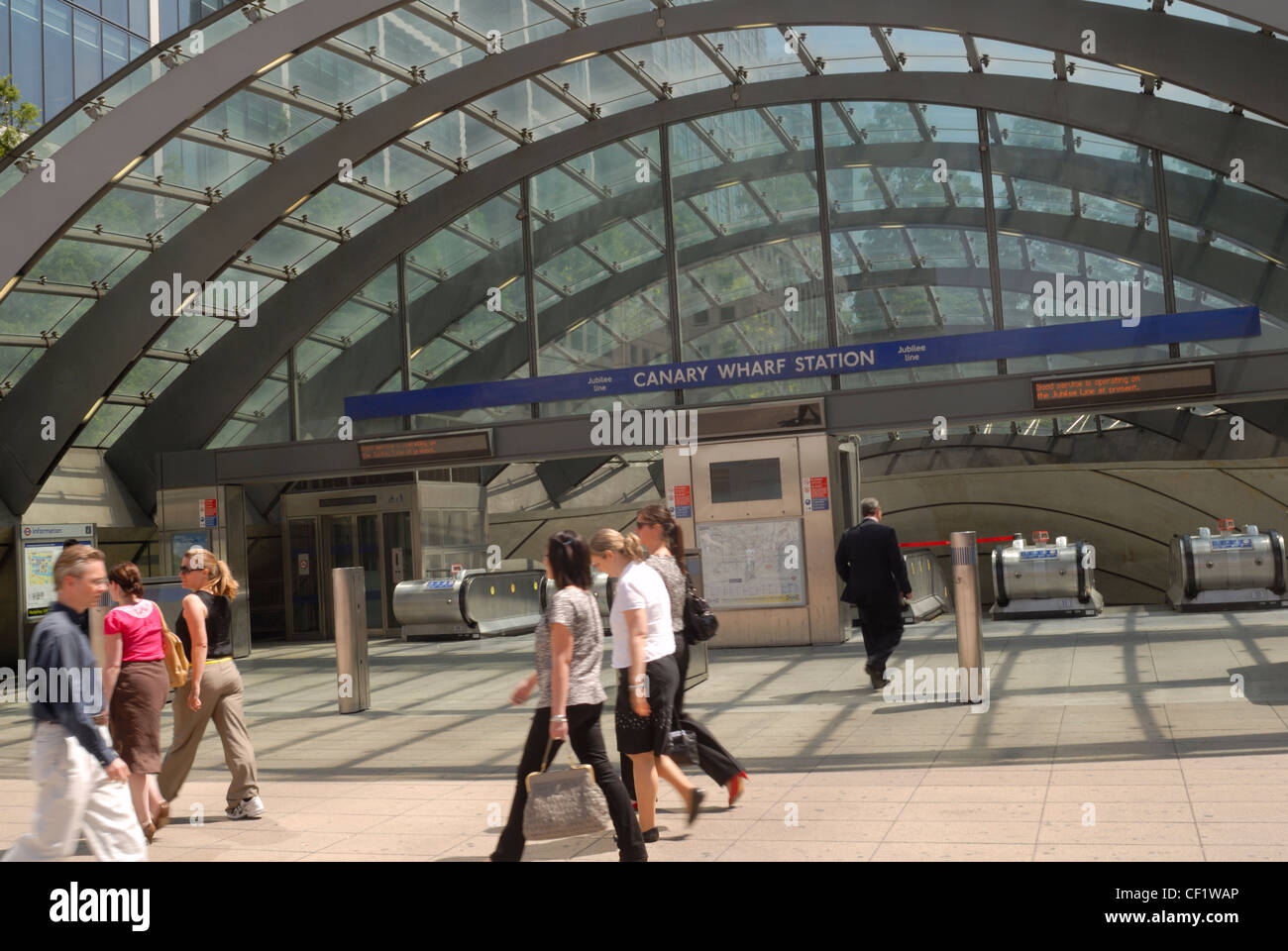 People passing the entrance to Canary Wharf tube station. Stock Photo