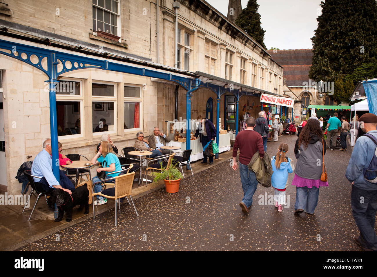 UK, Gloucestershire, Stroud, The Shambles weekly market, café customers sat outside on pavement tables outside market hall Stock Photo