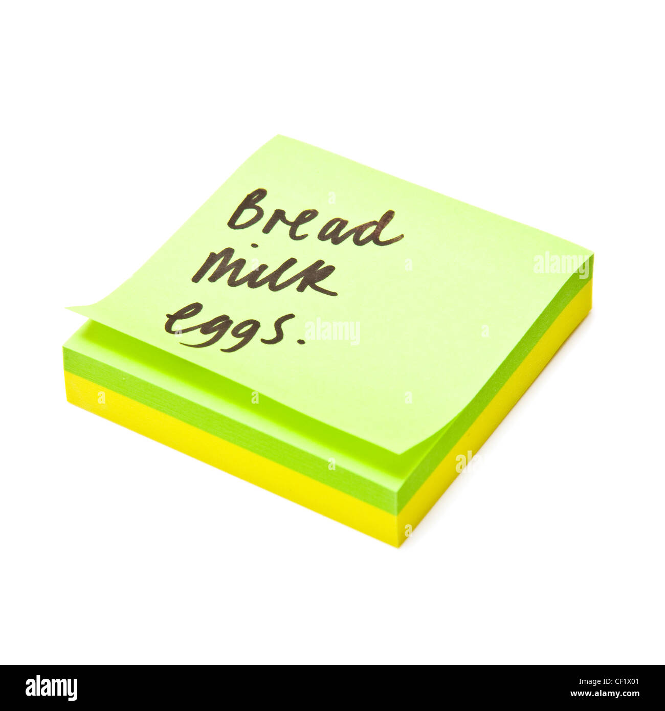 Shopping list written on a sticky note pad. Stock Photo