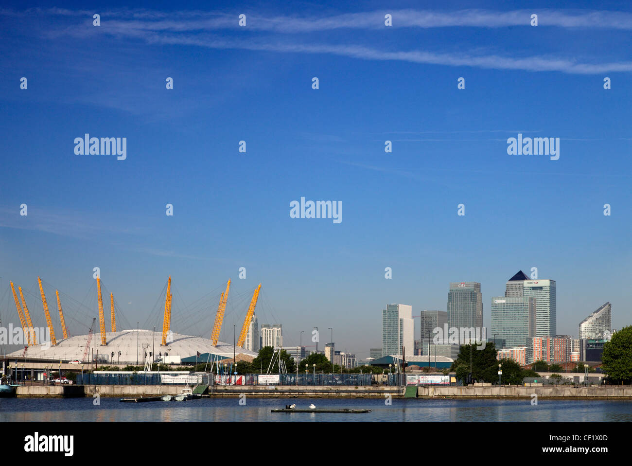 The O2 (formerly known as the Millennium Dome) on the Greenwich peninsula in South East London and the Canary Wharf development, Stock Photo
