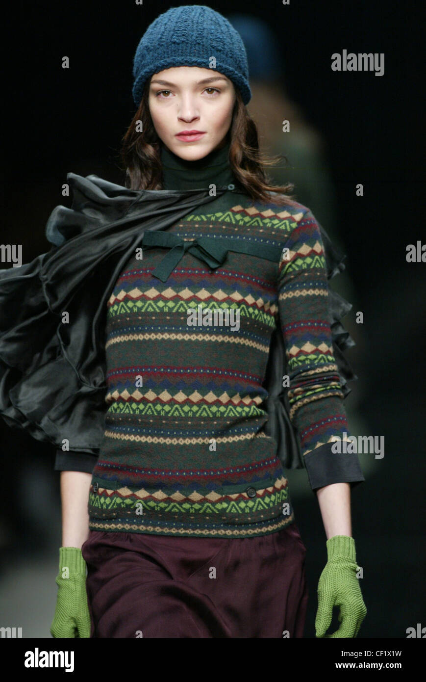 Burberry Milan Autumn Winter  Model Maria Carla long brunette hair wearing blue wool hat, multicoloured patterned jumper green Stock Photo