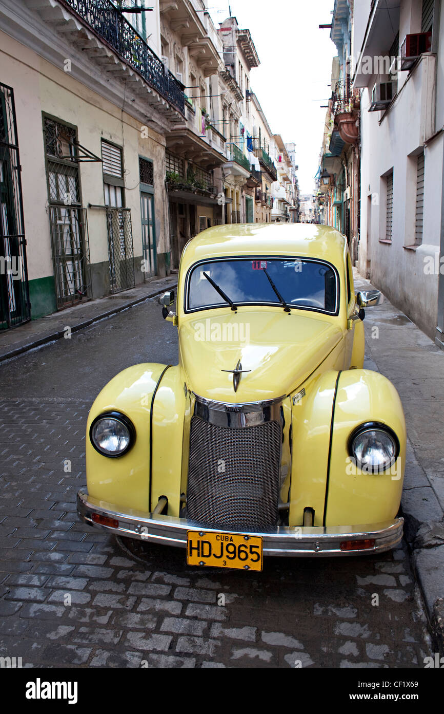 Bright yellow classic car in Havana, Cuba Stock Photo