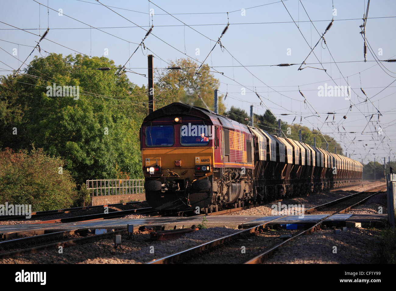 EWS 66143 Diesel Powered Freight Train Pulling Containers, East Coast Main Line, Peterborough, Cambridgeshire Stock Photo