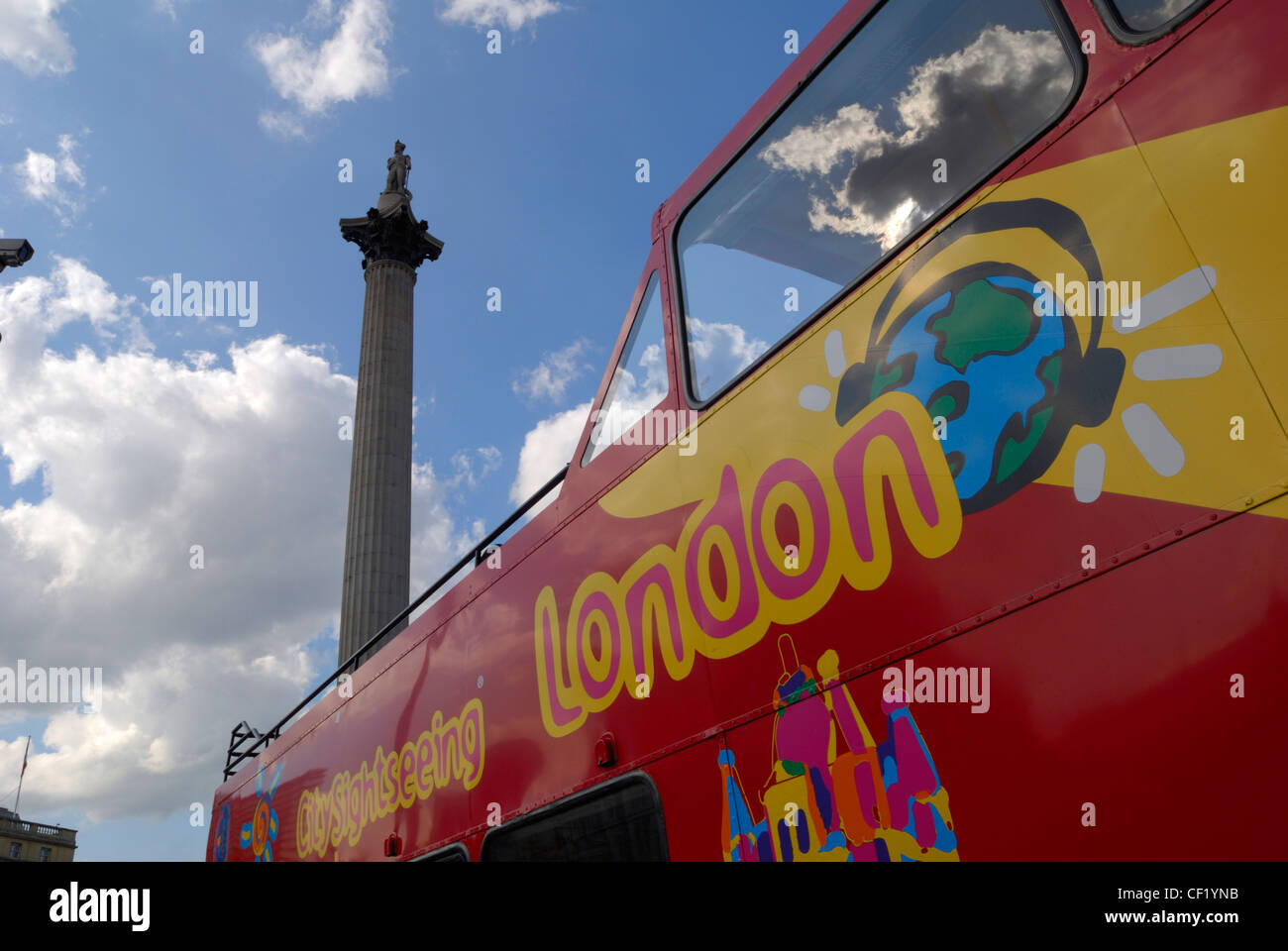 A London City sightseeing bus passing Nelson's Column in Trafalgar Square. Stock Photo