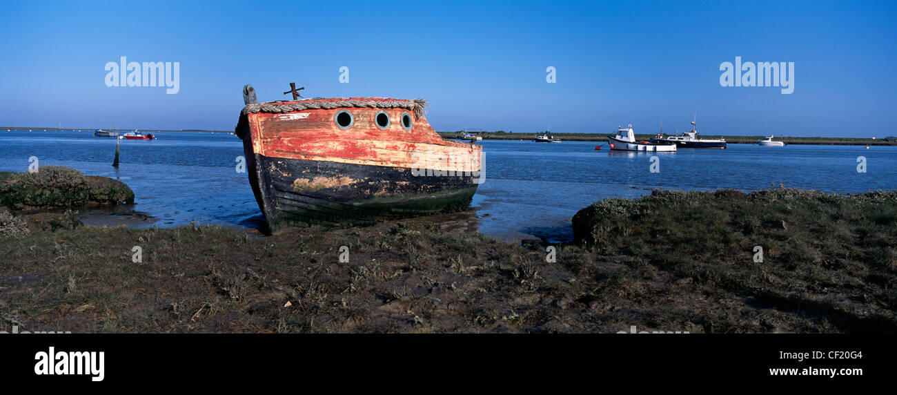 An old weathered boat on the shore of the River Ore at Orford. Stock Photo