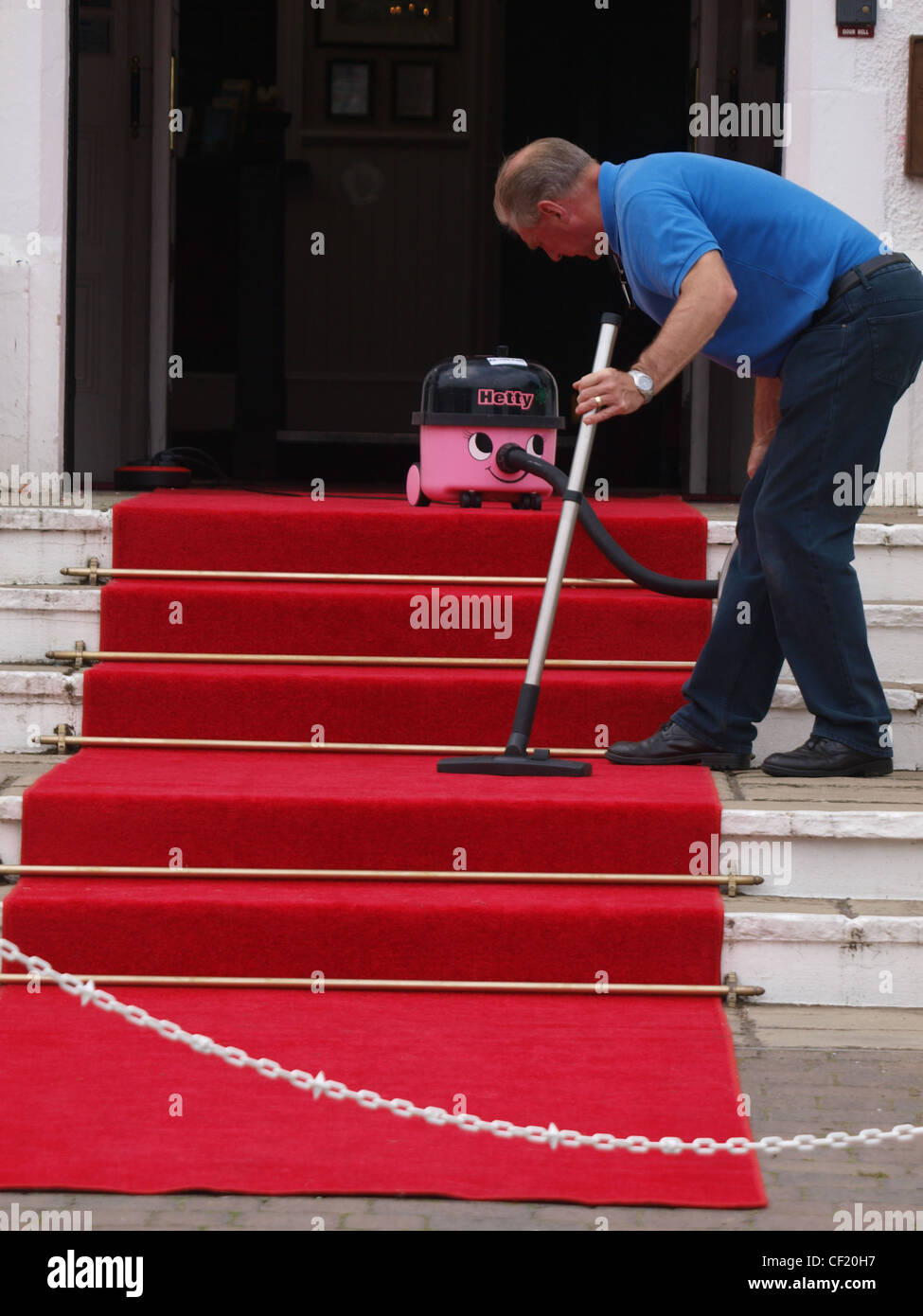 Hoovering the red carpet, Cornwall, UK Stock Photo Alamy