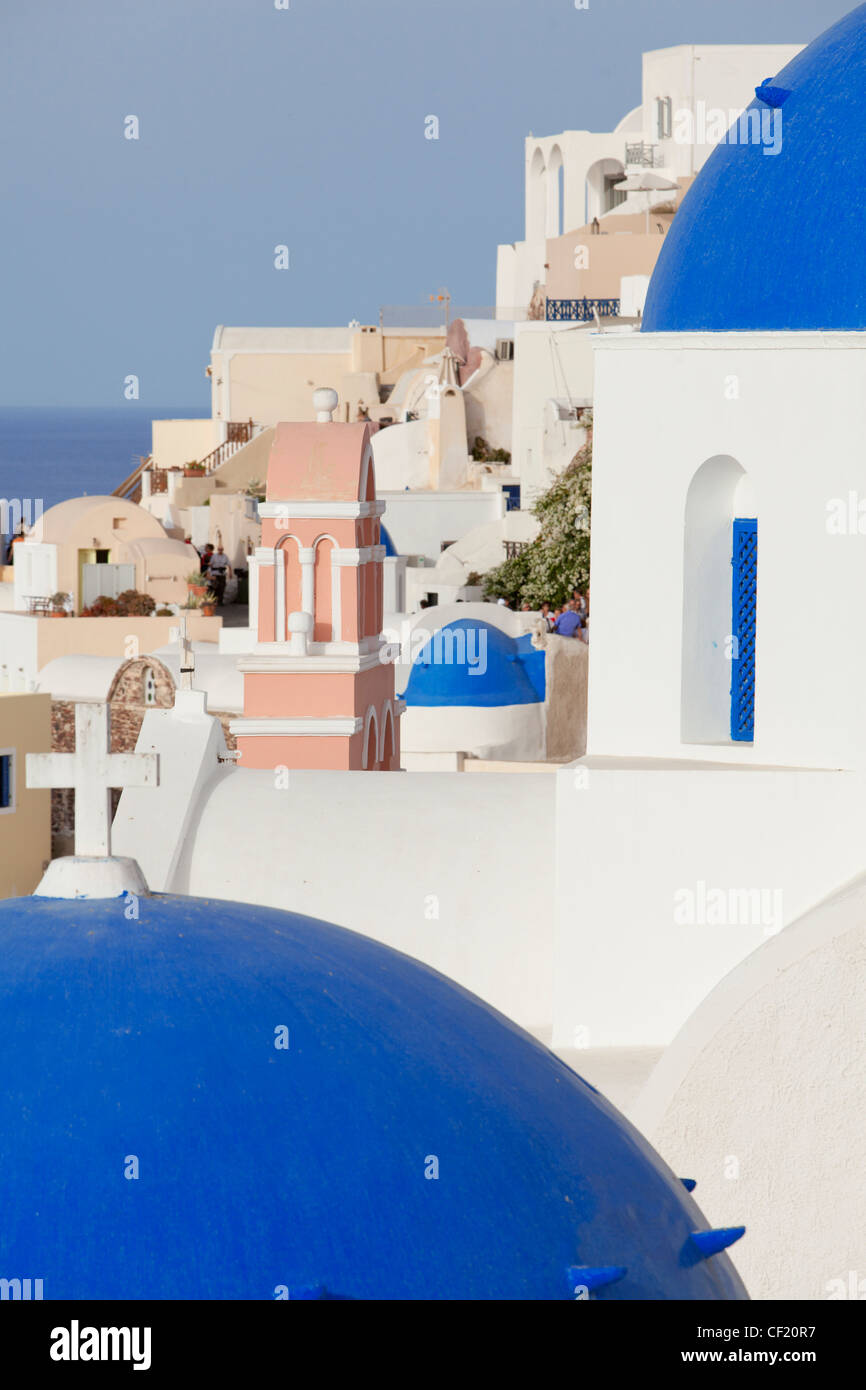 A view of the blue domed roofs of some Greek Orthodox churches in the village of Oia on