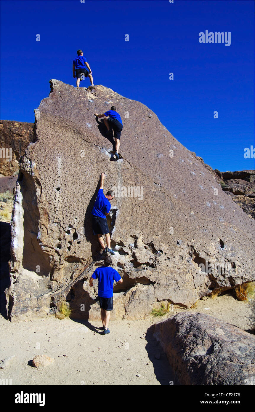 a composite series of a man rock climbing up a boulder Stock Photo