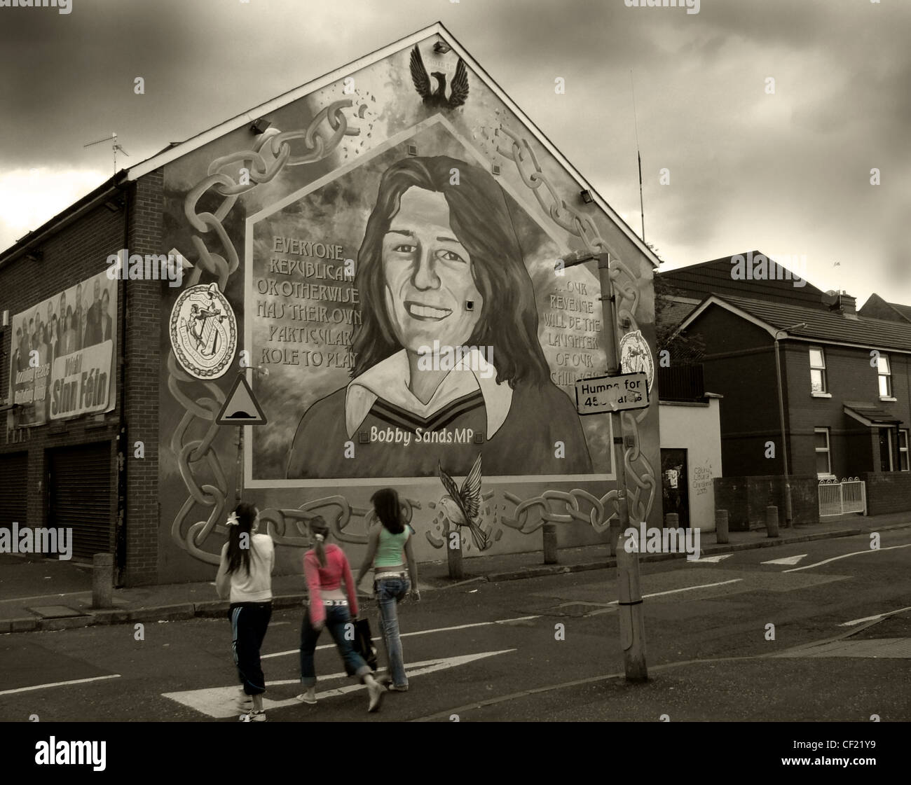 Bobby Sands mural painted on the side of Sinn Fein office on the Falls Road in West Belfast, Northern Ireland,photographed with a moody dark treatment Stock Photo