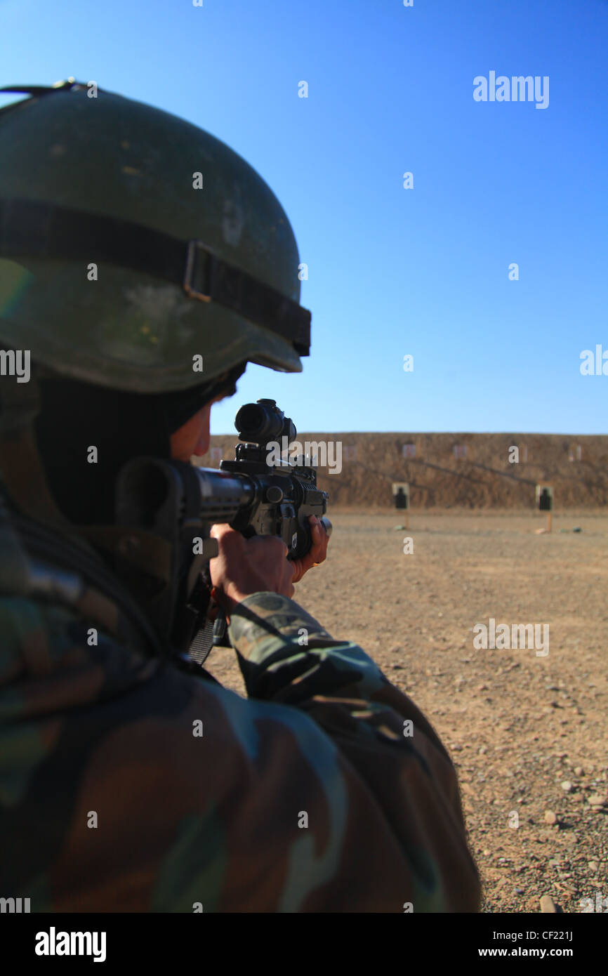 Afghan National Army commandos from the 3rd Commando Kandak participate in weapons training on a range in Kandahar district, Kandahar province, Afghanistan on Feb. 25. The commandos, partnered with coalition Special Operation Forces, practice weapons safety and rifle marksmanship to be better prepared to defend the people of Afghanistan. Stock Photo