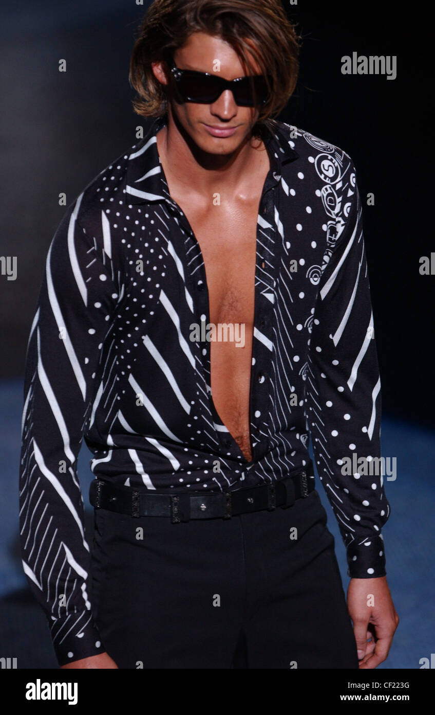 Versace Milan Menswear S S Male wearing dark shades with opened black and white patterned shirt Dark runway Stock Photo