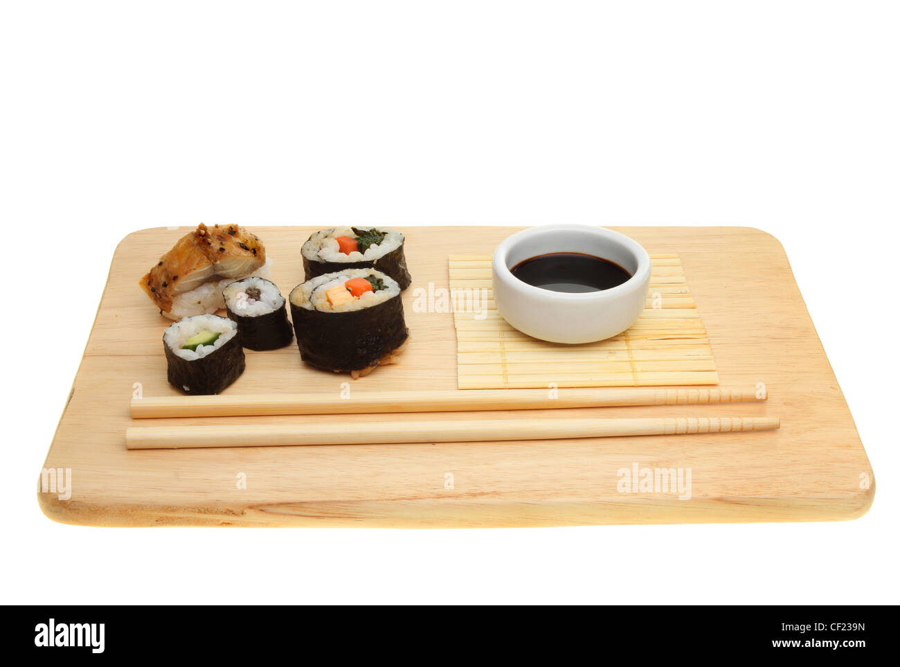 Japanese sushi,soy sauce and chopsticks on a board isolated against white Stock Photo