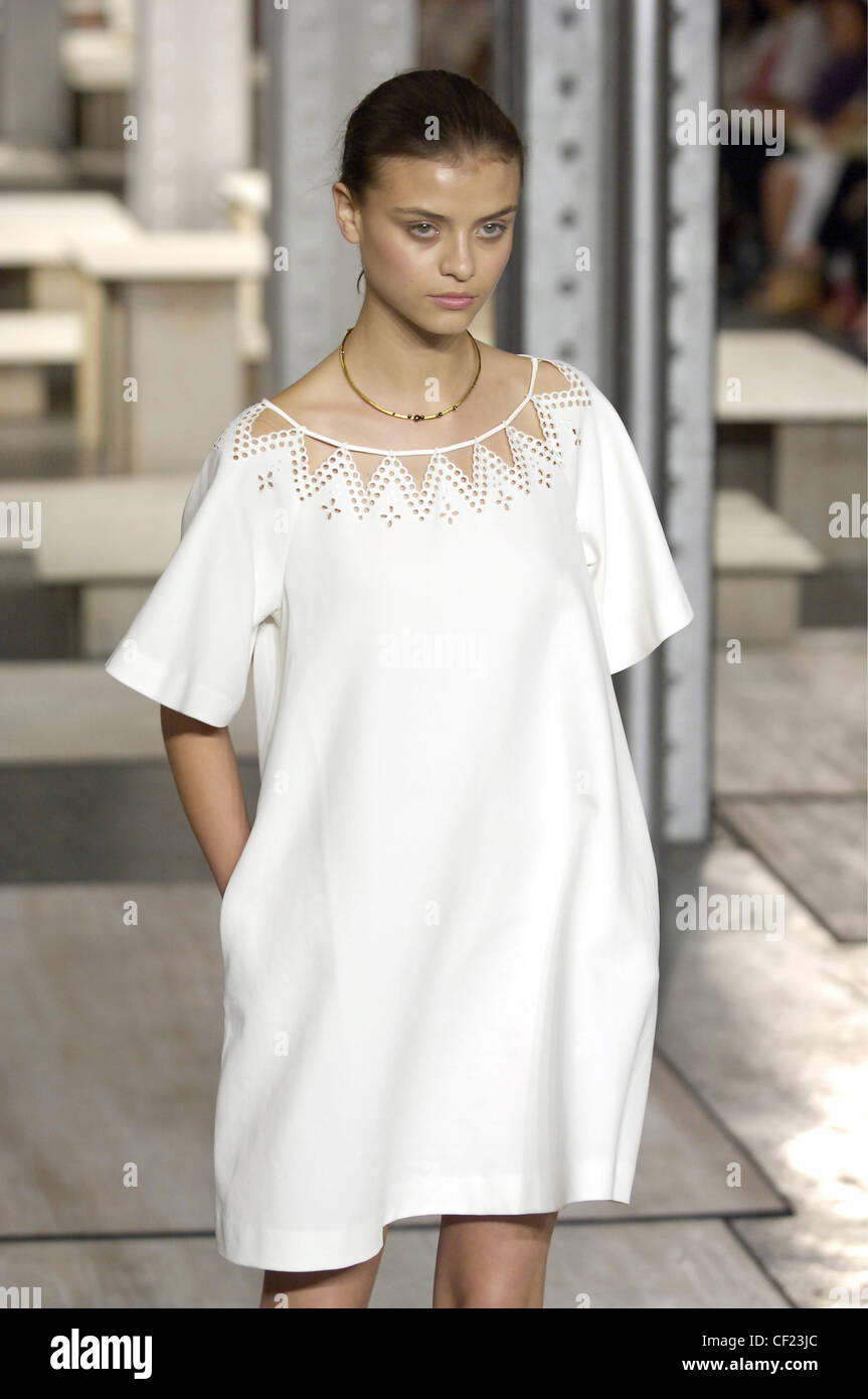 Phillip Lim New York Ready to Wear Spring Summer White shift dress perforated neck design and side pockets; models hair off face Stock Photo