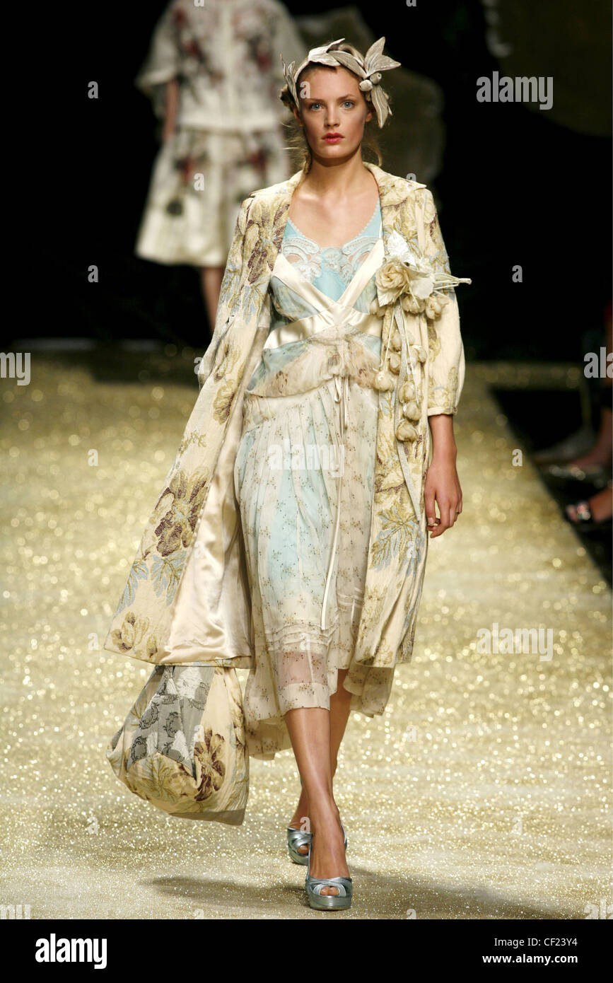 Antonio Marras Milan Ready to Wear Spring Summer Model wearing floral print  ivory overlay dress ivory satin floral overcoat and Stock Photo - Alamy