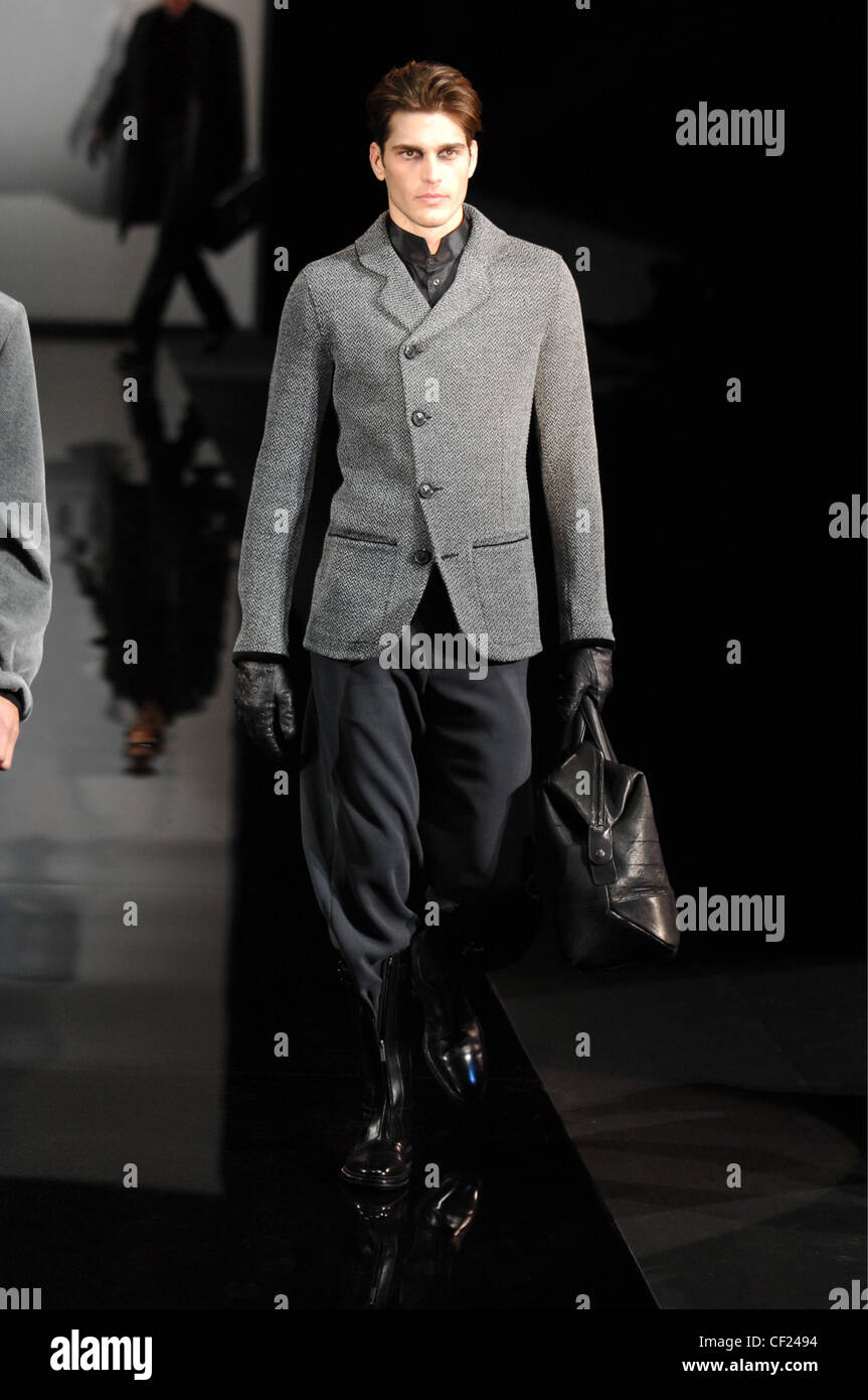 Giorgio Armani Milan Ready to Wear Autumn Grey Male model wearing asymmetric cut buttoned fitted tweed Stock Photo - Alamy