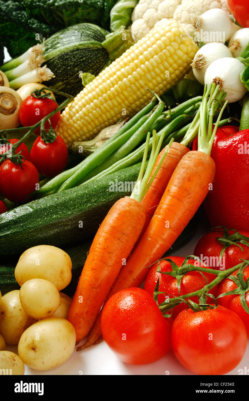 Selection of vegetables including tomatoes on the vine, red pepper