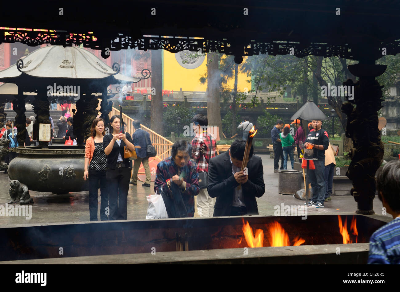 People bowing with incense sticks and praying for blessings at the Ling Yin Buddhist temple Hangzhou China Stock Photo