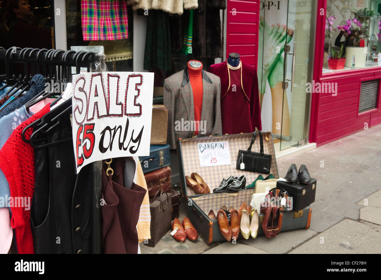 Secondhand clothes for sale outside a charity shop. London, UK. Stock Photo