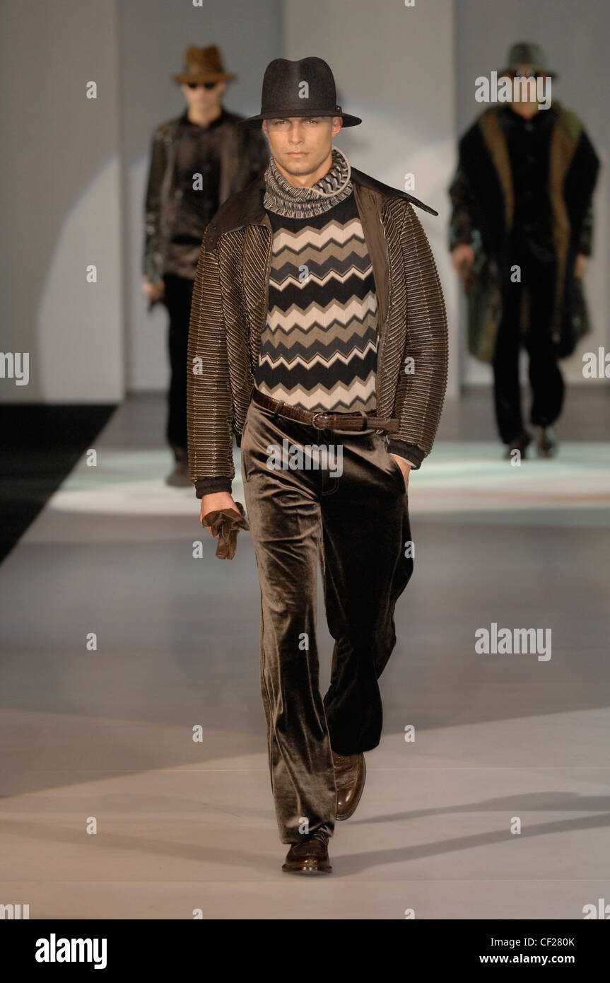 Giorgio Armani Milan Ready to Wear Autumn Winter  Brown Tones: striped waist jacket over zig zag print jumper and velvet Stock Photo