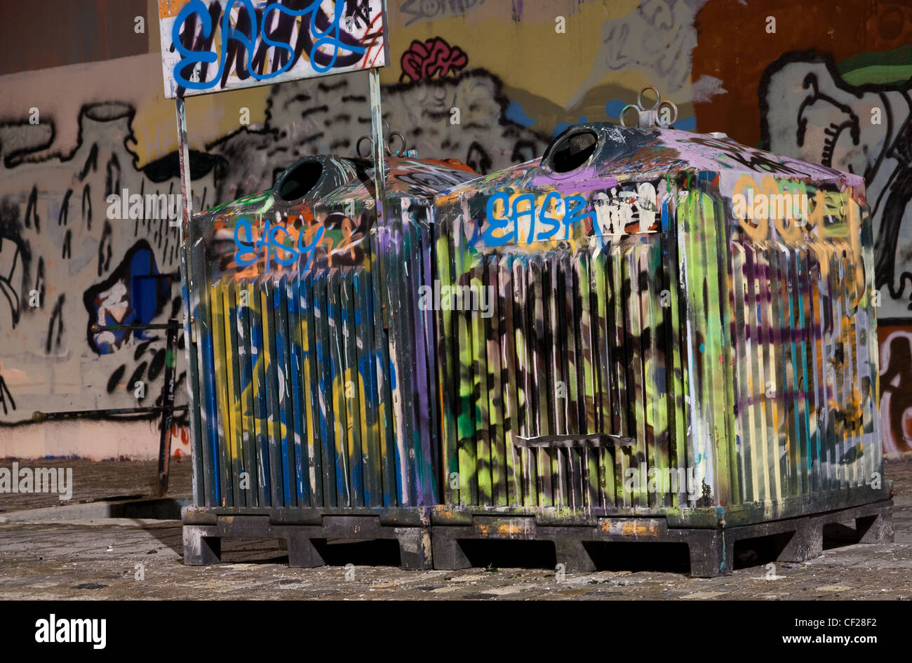 Picture of two tagged trashcans in a city Stock Photo