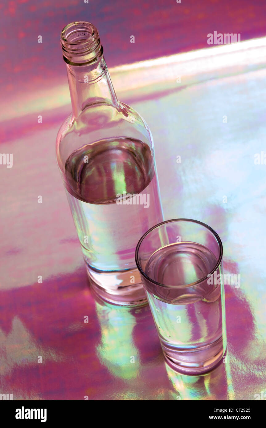 Still life shot a glass tumbler of water witht a clear glass bottle of