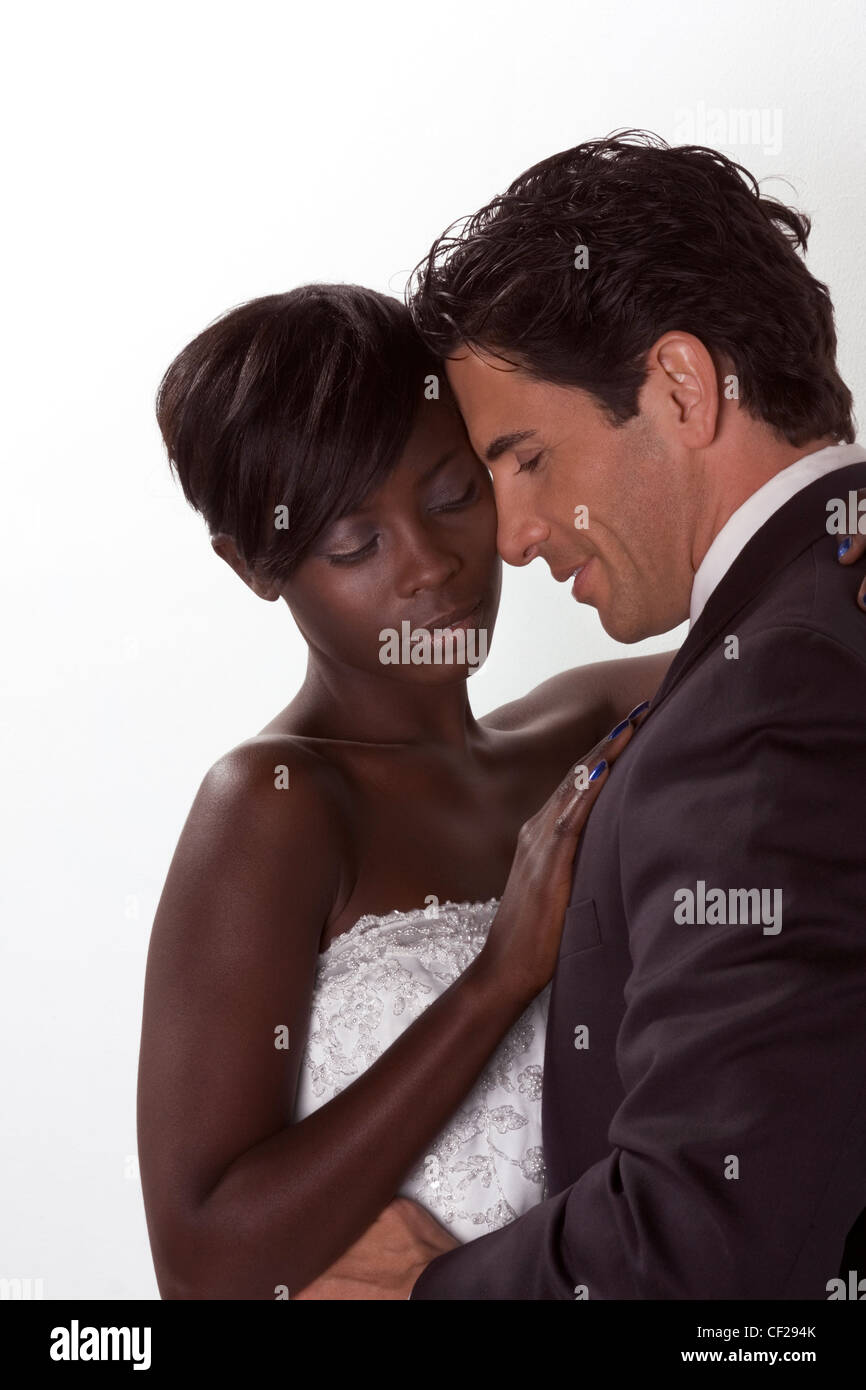 romantic newlywed young ethnic black African American woman and mid aged Caucasian man Stock Photo