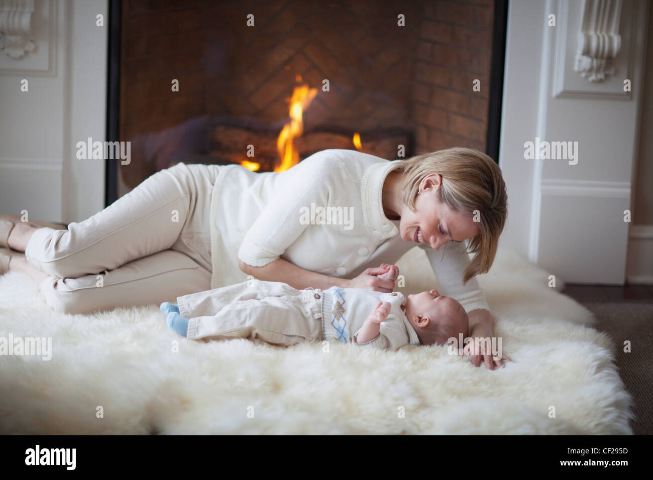 Mother And Baby On Carpet In Front Of Fireplace Jordan