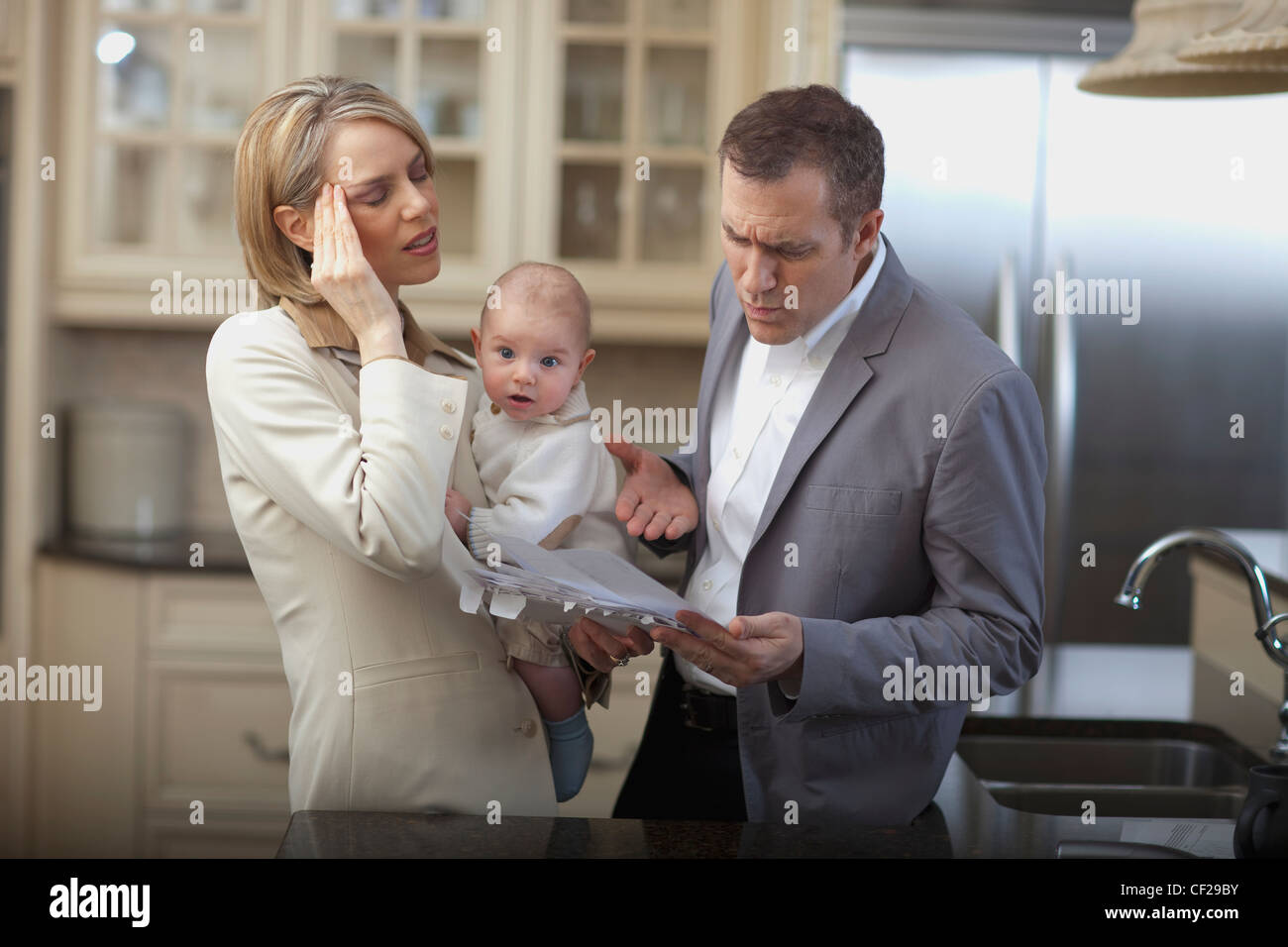 Husband And Wife With Baby Stressing Over Household Bills; Jordan Ontario Canada Stock Photo