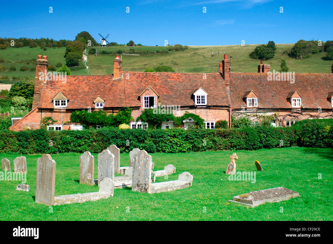 View across graveyard and cottages to the windmill at Turville. Turville is Anglo Saxon meaning 'dry field'. Stock Photo