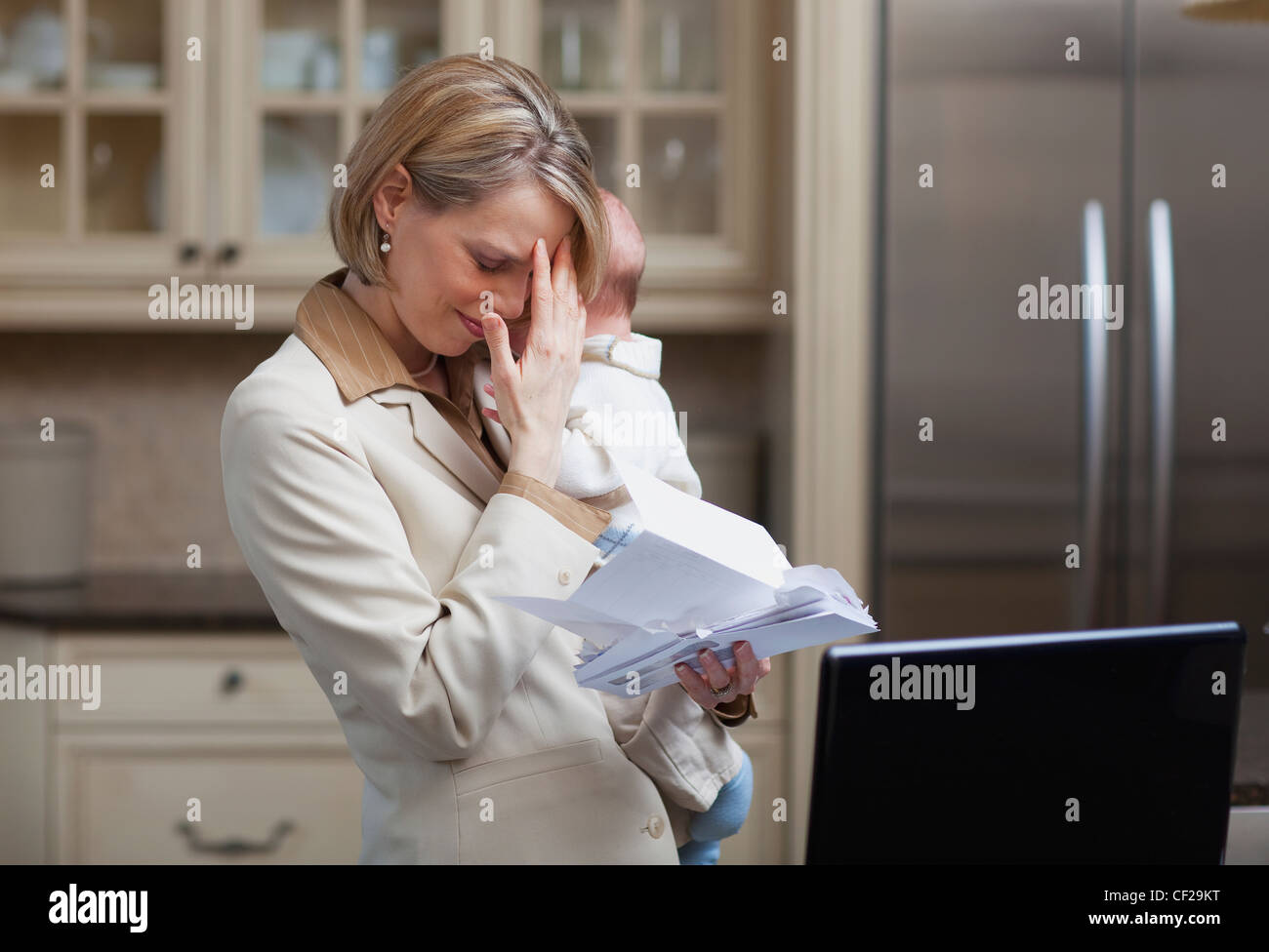 Mother With Baby Stressing Over Household Bills; Jordan Ontario Canada Stock Photo