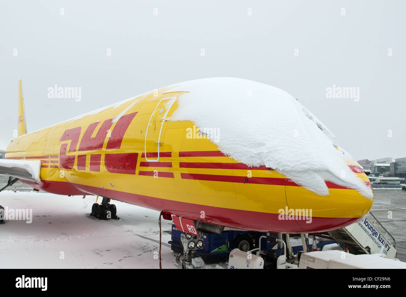 Snow covered DHL Boeing 757-200 freighter aircraft Stock Photo