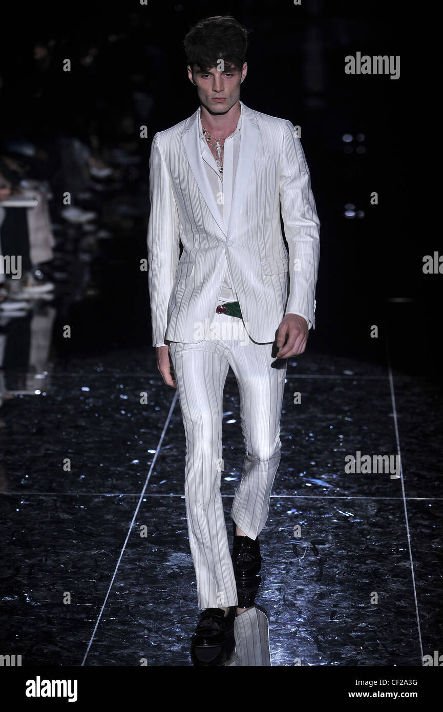 Gucci Milan Ready to Wear Spring Summer Model wearing white and silver  pinstripe suit, white shirt and black patent loafers Stock Photo - Alamy