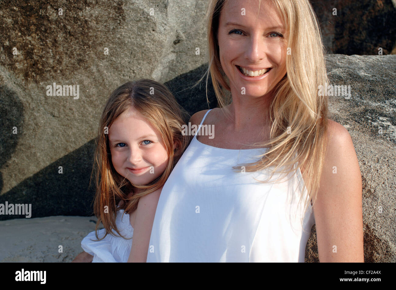 Mother and daughter wearing white dresses on a beach sitting together by rocks Stock Photo - Alamy Mother and daughter wearing white dresses on a beach sitting together by rocks Stock Photo - Alamy