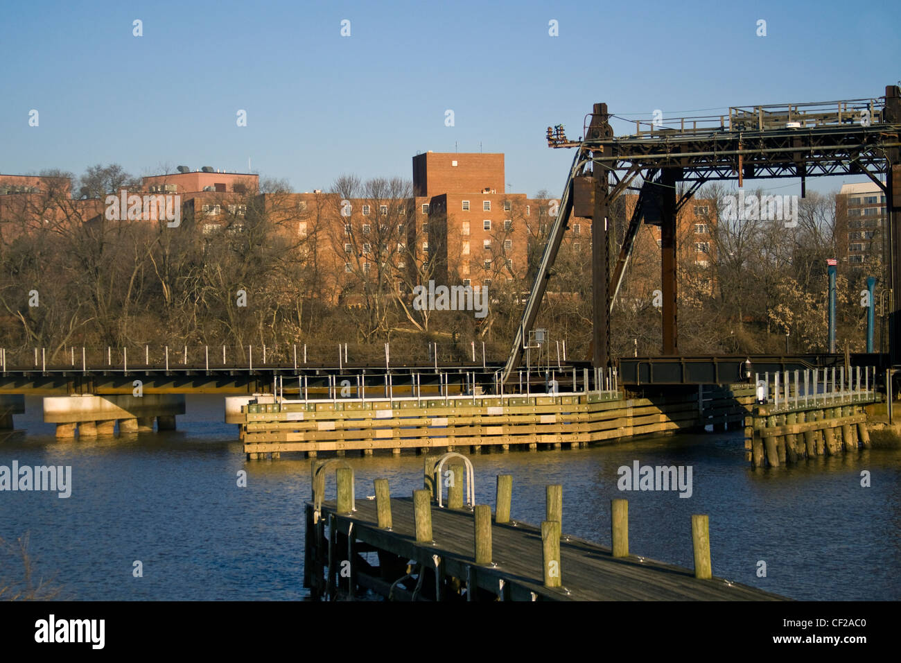 A CSX railroad bridge crossing over the Anacostia River and boat dock in Washington DC Stock Photo