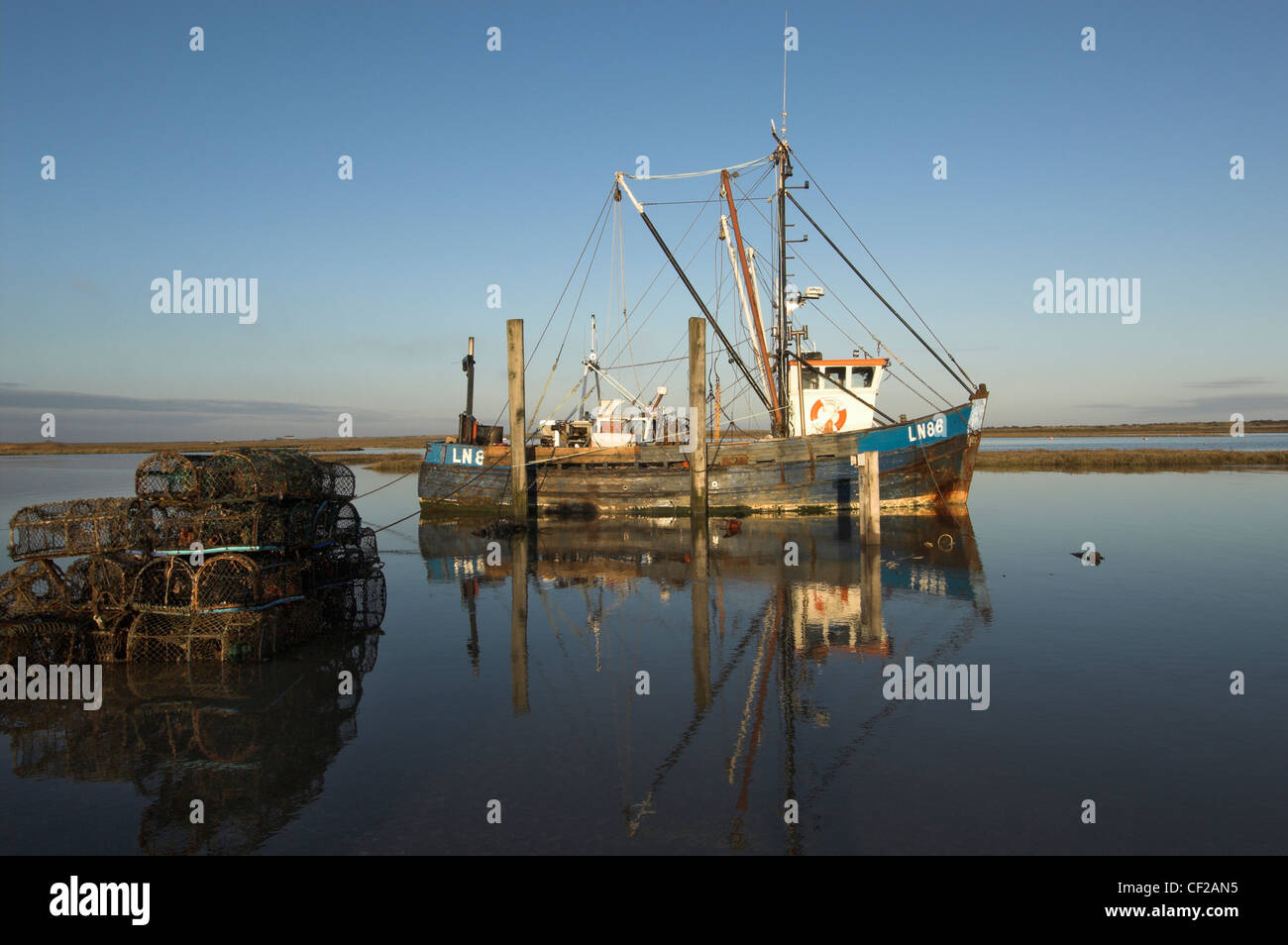 Fishing Boat at high tide, with lobster and crab pots. Stock Photo