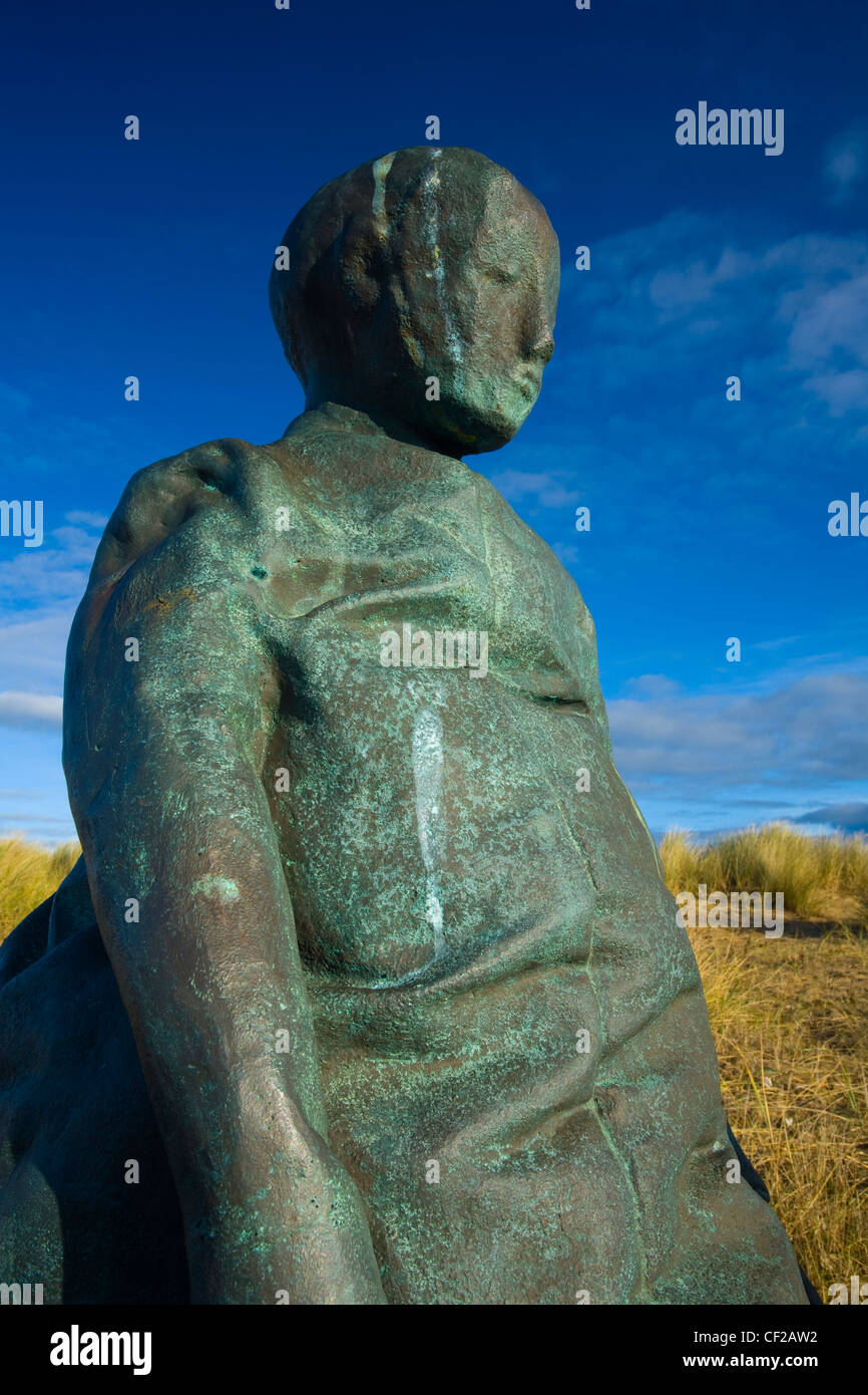 One of the 22 copper-bronze statues forming the 'Conversation Piece' artwork near The Groyne lighthouse at Littlehaven Beach, So Stock Photo