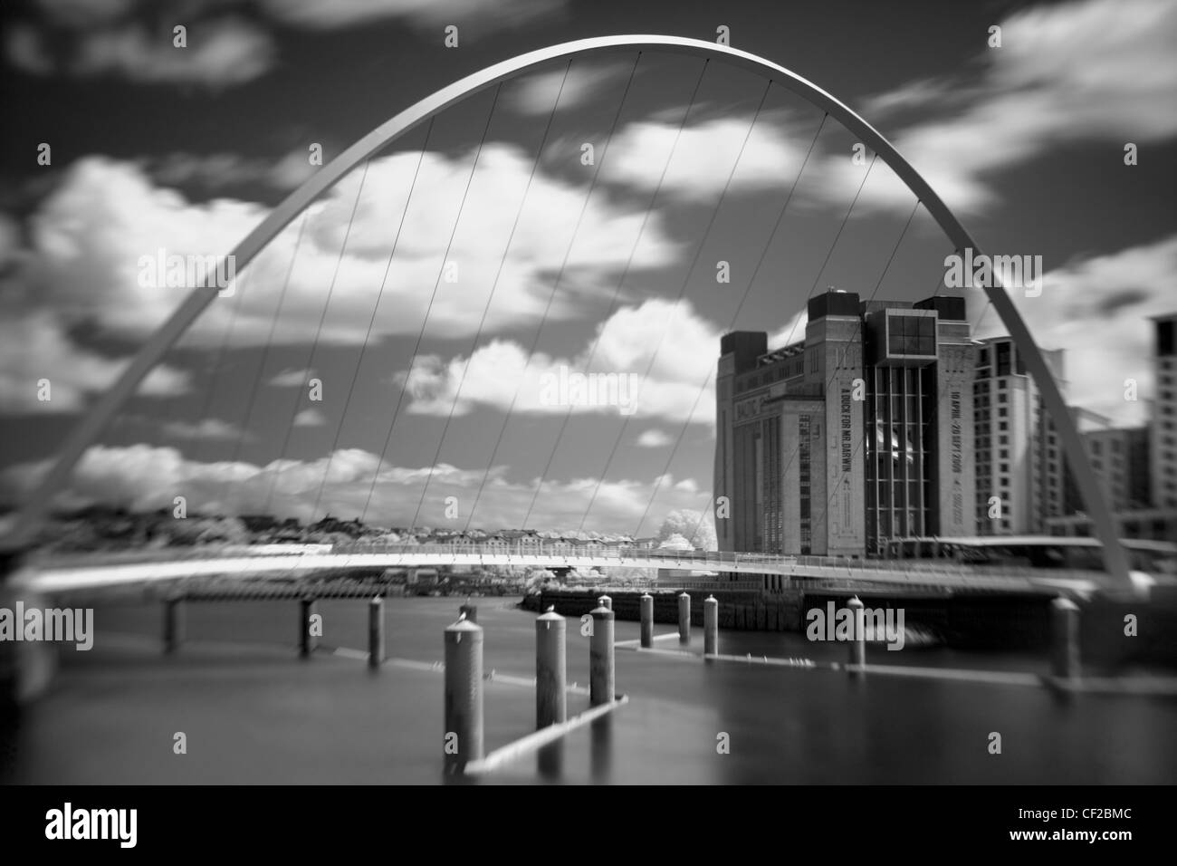 The Baltic Gallery in Gateshead, with the Millennium Bridge crossing the River Tyne. Stock Photo