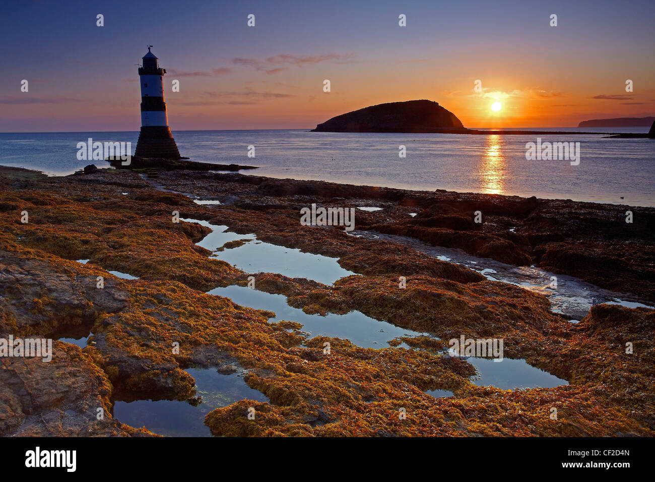 Penmon Lighthouse, also known as Menai Lighthouse, at the north entrance to the Menai Strait opposite Puffin Island at sunrise. Stock Photo