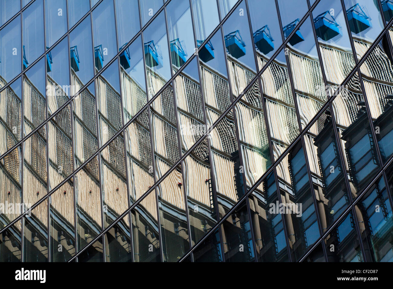 The Lloyds building is reflected in the mirror face of nearby offices to create an abstract view of modern architecture in the f Stock Photo