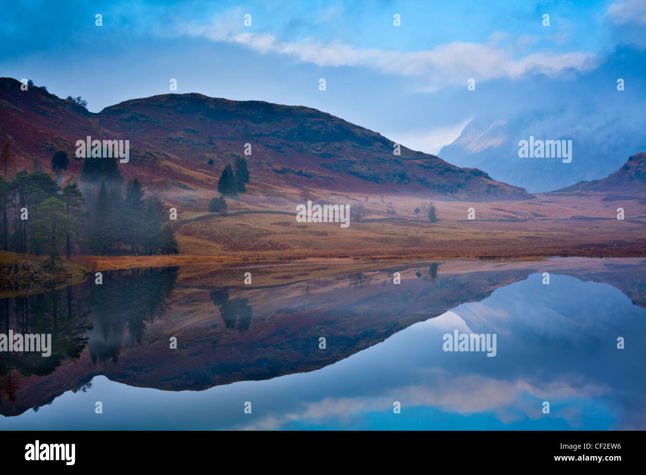 A misty dawn at Blea Tarn near Great Langdale in the Lake District. Stock Photo
