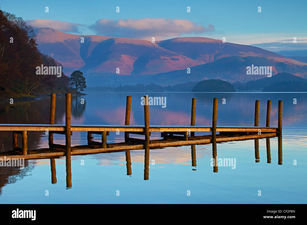 Brandelhow Jetty reflected in the still water of Derwentwater in the Lake District National Park. Stock Photo