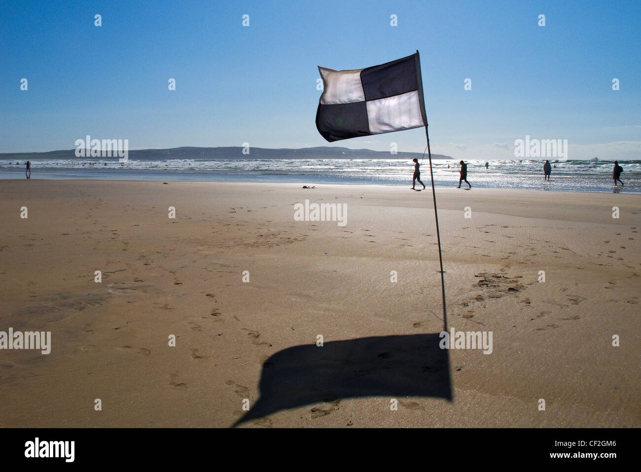 A lifeguard warning flag on Gwithian Beach indicating that surfcraft over 5 feet in length should not go beyond this point. Stock Photo