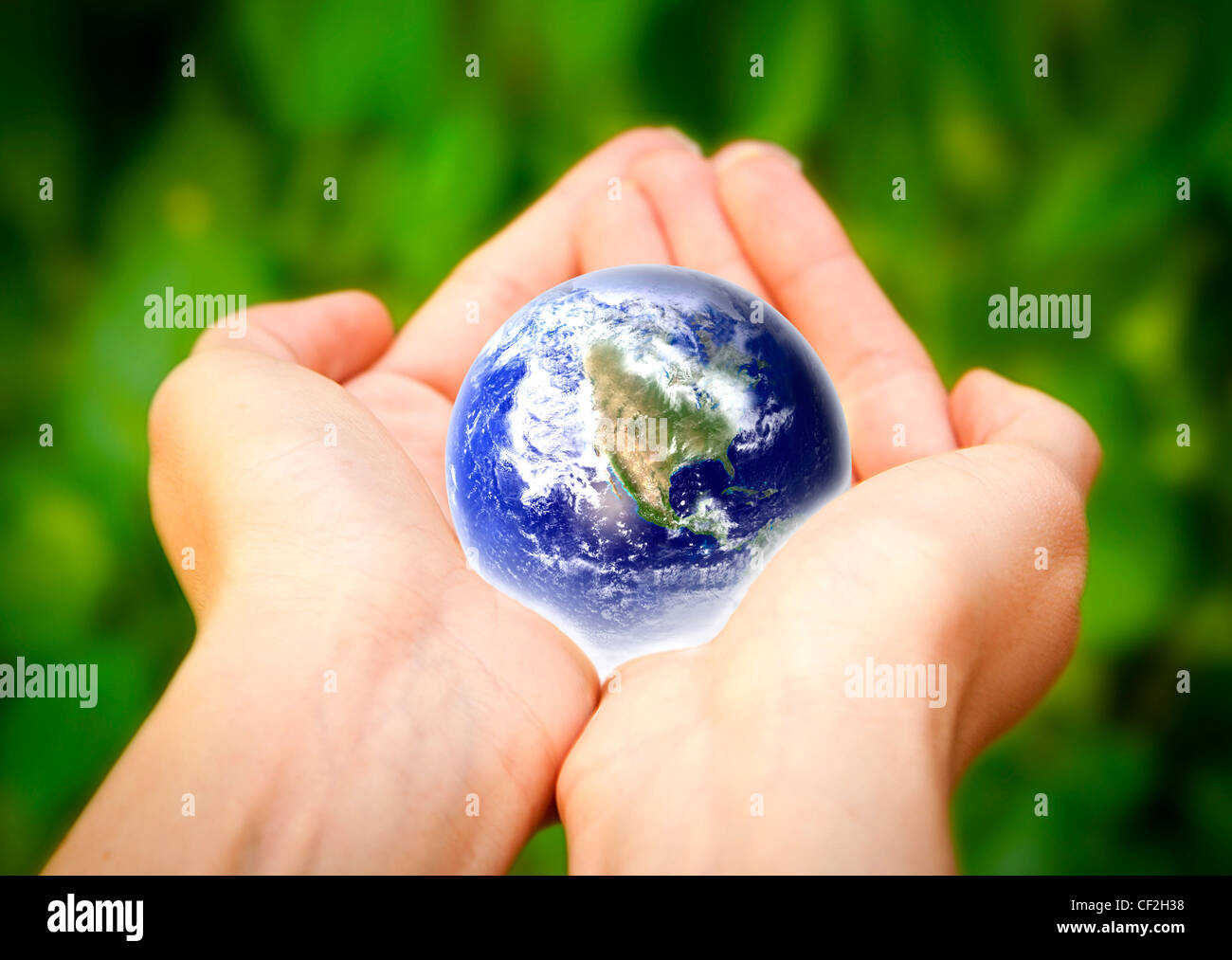 human hands carefully holding Earth planet. Glass World Stock Photo