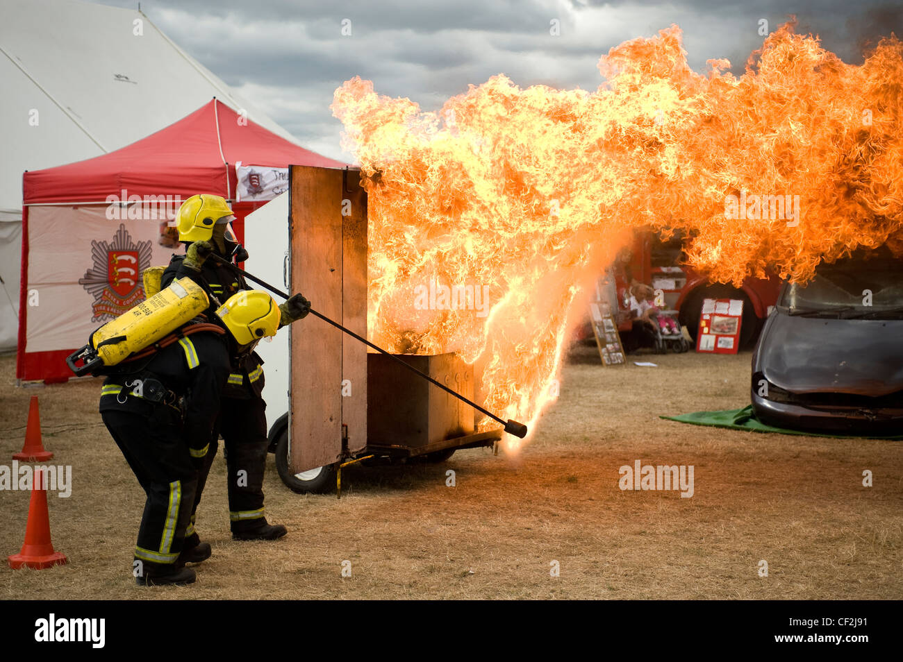 Firemen from the Essex Fire Service demonstrating the dangers of a chip pan fire at the Orsett Show, one of the oldest one-day C Stock Photo