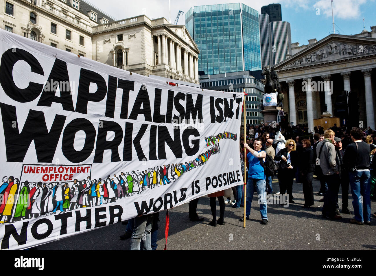 Protestors holding a large banner stating 'Capitalism Isn't Working' at the G20 demonstration in the City of London. Stock Photo
