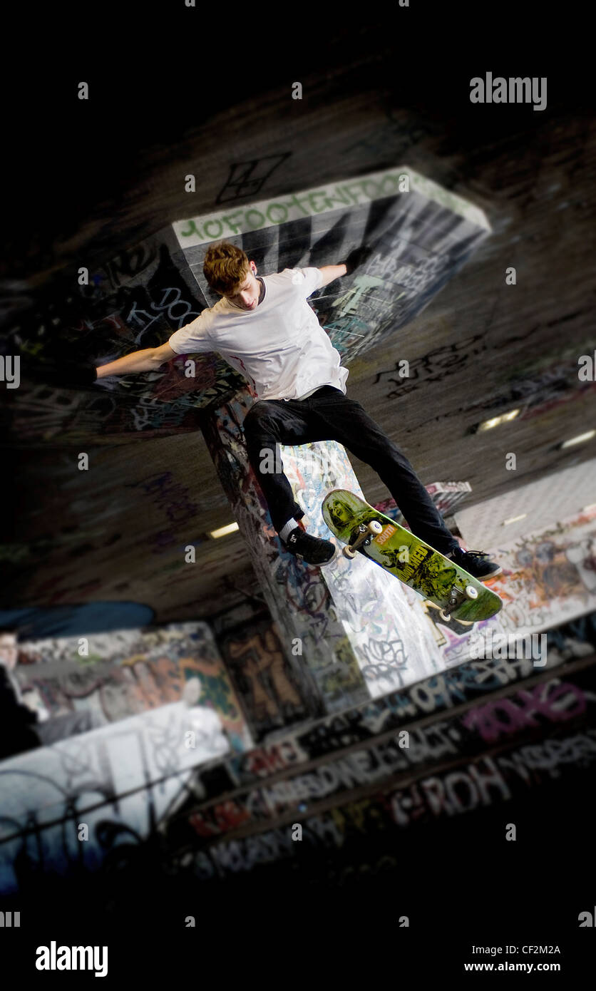 A skateboarder performing a stunt at the undercroft on the South Bank. Stock Photo