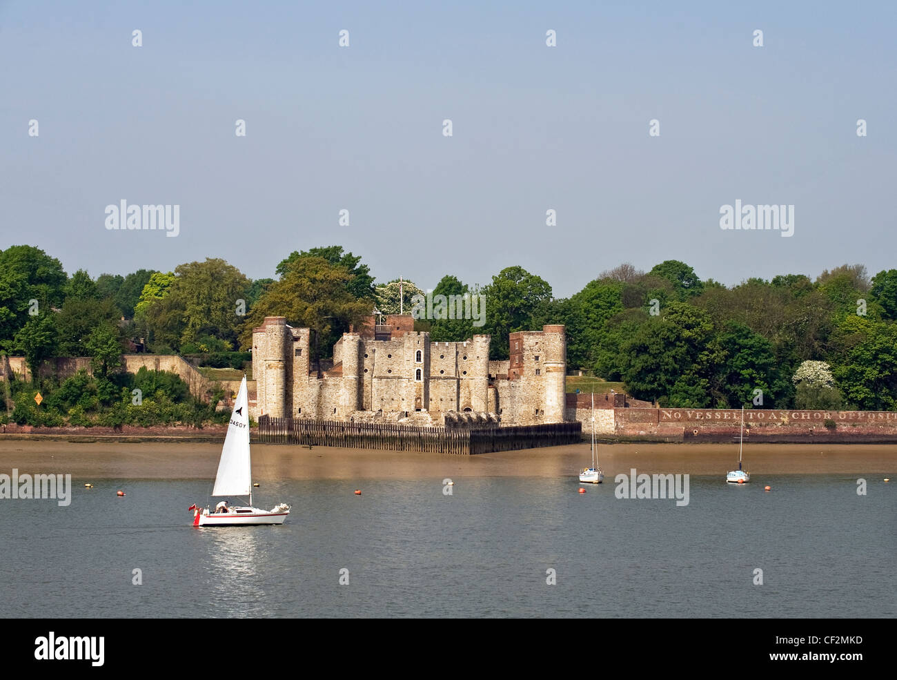 A sailboat sailing on the River Medway past Upnor Castle. Stock Photo
