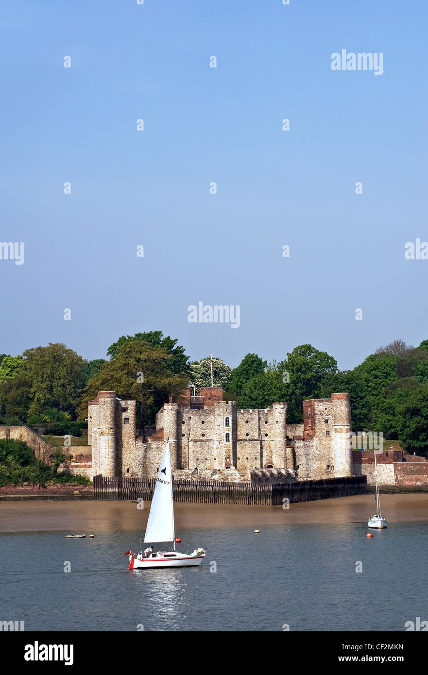 A sailboat sailing on the River Medway past Upnor Castle. Stock Photo