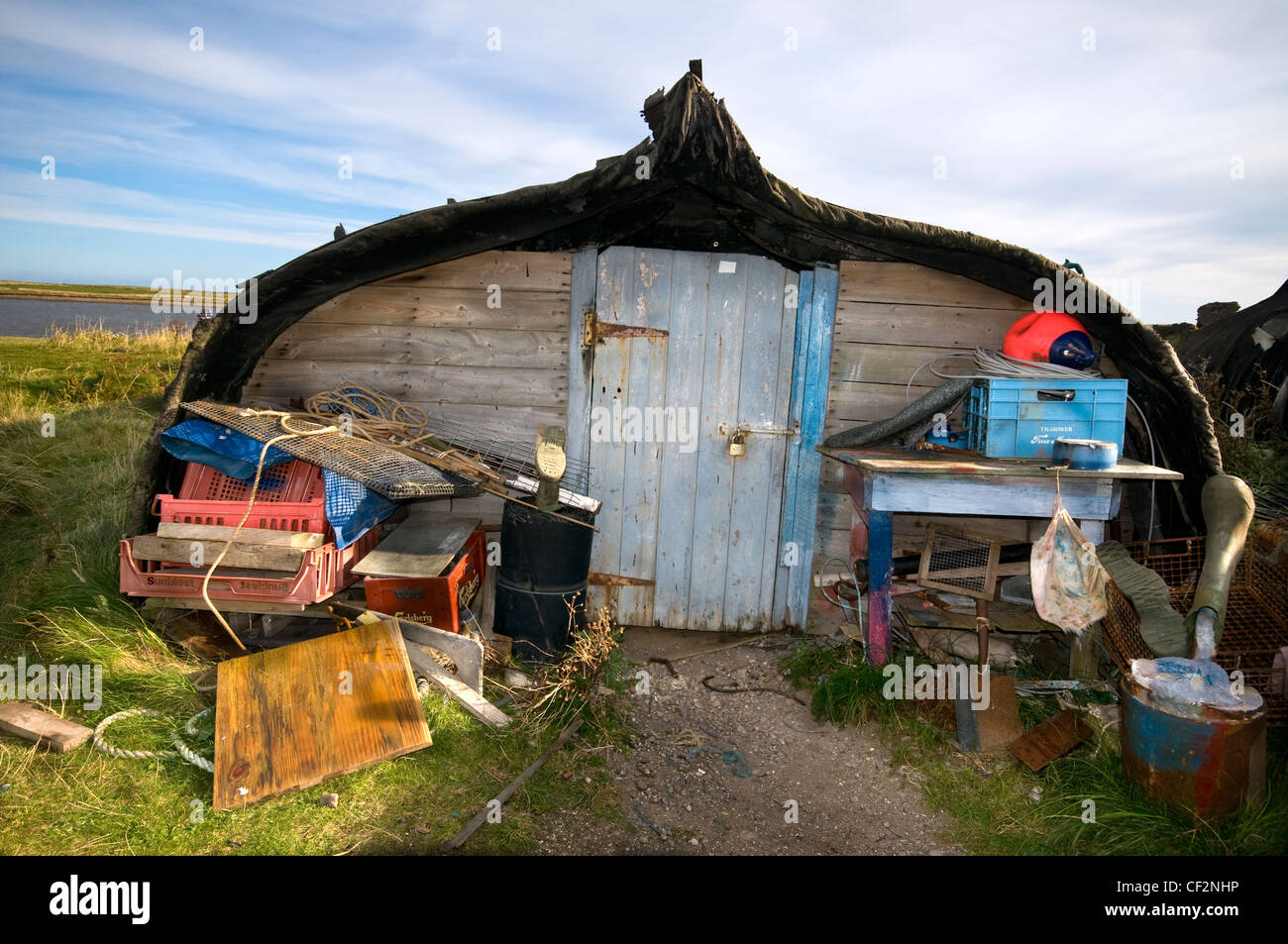 An unusual shed around the harbour on Holy Island, converted from an old herring fishing boat. Stock Photo